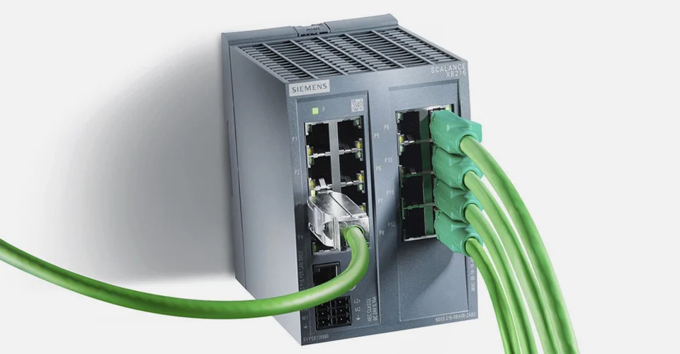 Comdiel_img_1 | Atwix Siemens Scalance Xb216 Industrial Ethernet Switch with Multiple Green Network Cables Connected.